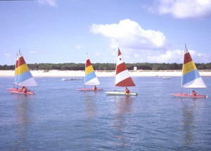 While the kids learn to dinghy sail, you can relax on the beach