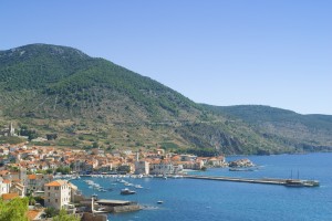 Komiza: The harbour and town, showing the long (and unusually empty) breakwater