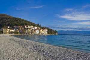 Moscenicka Draga: The beach and village with the boulders of the harbour walls visible