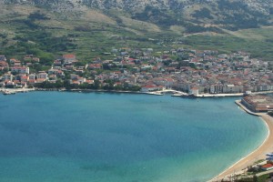 Pag: The ferry quay, left, and yacht quay, right, with the channel markers in front