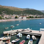 Petrovac: The busy beach looking across the small harbour