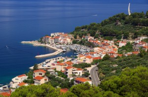 Podgora: The harbour, with modern sculpture on the hill above the town