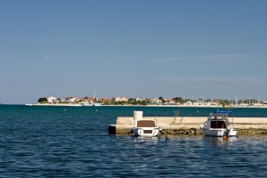 Sukosan: Looking towards the entrance and fuel quay with the many masts of moored boats visible