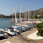 Datca: Yachts on the town quay with boats at anchor in the bay